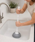 Slick Modern Toilet Plunger With 19 Inch Handle And Gray Rubber Cup Kicks Clogs Fast And Features A Snazzy Three Piece Design in use.