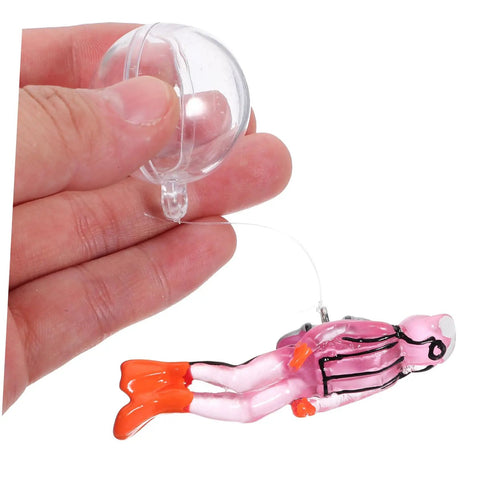 Floating Diver Aquarium Decor For Fish Tanks being held by a hand, showing the resin diver ornament with glowing pink suit