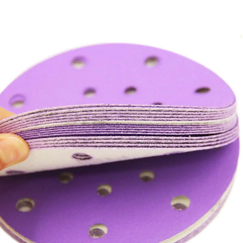 Get Ready To Polish Like A Pro With This Awesome 100 Piece 6 Inch Wet Dry Hook And Loop Sanding Discs Assortment Featuring 320 Grit Plus Many More For Wood Drywall And Metal Projects That Suck Less, showcasing purple 6-inch sanding disc with holes.