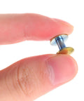Close-up of Two Piece Titanium Alloy Binding Screws For Heavy Duty Document Sorting and Hella Durable Scrapbook Fasteners held in hand.