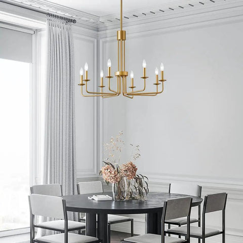 Modern Gold 8 Light Chandelier With Candlestick Lights in dining room over table, featuring farmhouse style design.