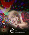 Star Projector Night Light With Timer For Kids 360 Degree Rotating Moon And Stars Sky Projector Lamp next to a sleeping child