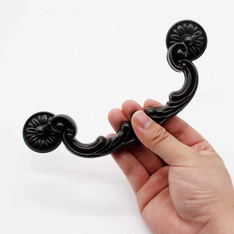 Holding a vintage style zinc alloy drop down bail pull handle, part of the set of 4 rustic handles with 151mm hole center, 185mm length.