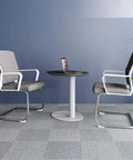 Heavy Duty Pneumatic Lectern With Smooth Height Adjustment Mobile Presentation Podium Built Like A Tank No Sweat Setup Rock Solid Base Perfect For Churches Offices Classrooms Straight Up Reliable meeting setup with two stylish gray chairs and a black round table.