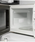 Open microwave with installed 30 Pcs Oven Mica Plates And Microwave Mica Sheets Heat Insulation Covers for appliance protection