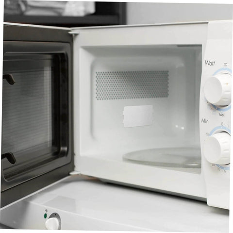 Open microwave with installed 30 Pcs Oven Mica Plates And Microwave Mica Sheets Heat Insulation Covers for appliance protection