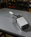 Heavy Duty DC Voltage Step Down Converter Swaps 36V Or 72V Straight To 12V with compact design on a workbench.