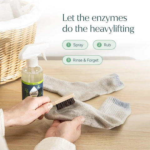 Person cleaning sock with Travel and Laundry Stain Remover for Clothes and Baby Gear Unscented spray and brush.
