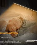 Go-To Smart Desk Lamp With 10W Wireless Charger And USB Port illuminating a sleeping child, showcasing its eye friendly LED