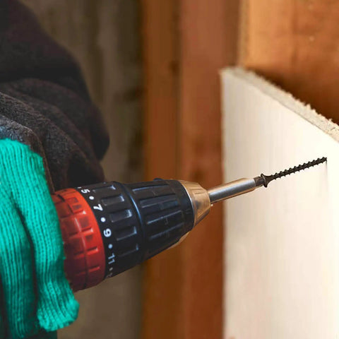 Built Like A Tank Number 8 X 1-1/4 Inch Black Phosphate Coated Stainless Steel Truss Head Wood Screws 100 Pack Heavy Duty Self Tapping drywall fasteners being installed with a power drill.