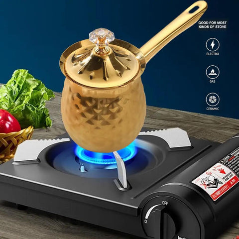 Gold Hammered Stainless Steel Turkish Coffee Cezve 7 Oz 200 Ml Ibrik With Heat Resistant Handle And Lid shown on stovetop brewing coffee