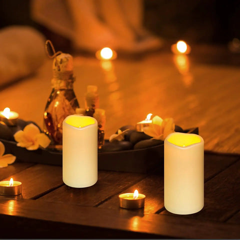 Waterproof Flameless LED Pillar Candles With Remote Timer Battery Operated Pack Of 3 in outdoor setting on wooden table.