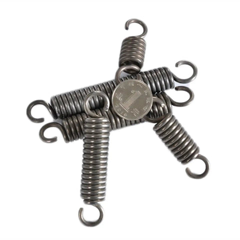 Extension Compression Springs Kit With 1.2mm Wire Diameter And 12mm Outer Diameter next to a coin for size reference.
