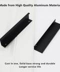 Two matte black concealed tab cabinet pulls in solid aluminum, 150 mm length, for cabinets and drawers.