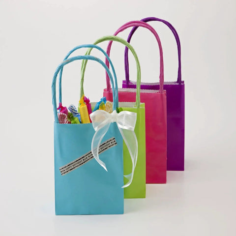 Slick Portable Monochrome Label Maker Featuring Qwerty Keyboard And Crisp Display Designed For Home Office Organization Includes Four Nifty Tape Rolls For Dead Simple Everyday Printing Tasks, shown with colorful gift bags for organization.