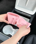 Person holding a pink Slick Drop In Premium Soft Silicone Cup Holder Insert For Tesla Model 3 Highland 2024 And Up.