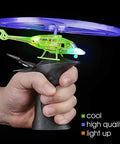 Person holding Light Up Flying Helicopters Set Of 2 With LED Lights And Handheld Launcher, showing glowing features.