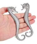 Two seahorse shaped drawer pulls ocean theme marine style cabinet hardware zinc alloy coastal metal decorative pulls in hand.