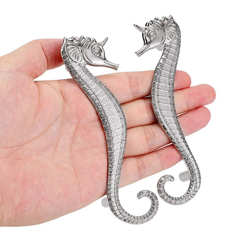 Two seahorse shaped drawer pulls ocean theme marine style cabinet hardware zinc alloy coastal metal decorative pulls in hand.