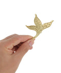 Hand holding vintage brass leaf cabinet drawer pull handle for kitchen cabinets dresser nightstand and wardrobe left side mount