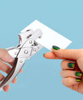 Hand using Heavy Duty Single Hole Punch Plier For Office And Crafting Handheld Paper Punch Tool For Cardstock Loose Leaf Sheets Badges