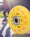 Close-up of a Transparent Yellow PU Casters Wheel For Luggage Carts 64mm showing smooth rolling feature outdoors.