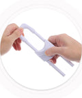 Hands holding 6 Piece White Childproof Cabinet Lock For Babies focusing on no drill plastic safety feature