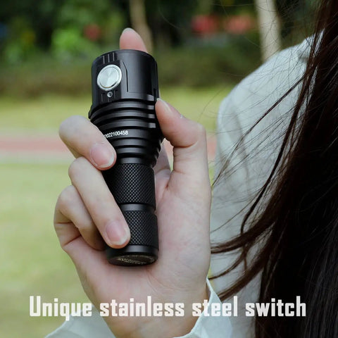 Hand holding Ultra Bright EDC Flashlight 13000 Lumens With Cree XHP70.2 LEDs, focusing on the unique stainless steel switch.