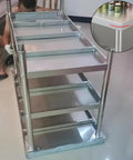 Beefy Stainless Steel Workbench With Three Tier Open Shelving And No Fuss Leveling Feet, showcasing robust construction and shelving.