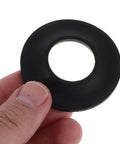 Close-up of a hand holding a black rubber bathtub drain gasket washer, part of 10pcs Rubber Bathtub Drain Gasket Washer for Easy Installation.