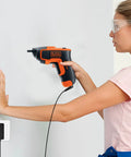 Woman using Go To 10V Charger Replacement Power Adapter For Black And Decker Li2000 Li3100 Cordless Screwdriver And Drill Models 90593303 90593303 01 Compatible 100 240V AC Input And 10V 100mA Output to drill into wall