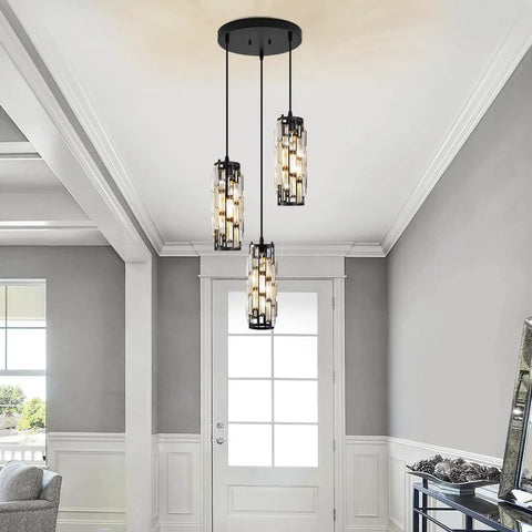 3 Light Pendant Chandelier With Bulbs Included, crystal prisms, matte black frame, hanging in a modern dining room, adjustable cord