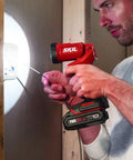 Man using LED spotlight from 4 Tool Power Kit With 20V Cordless Drill Driver Impact Driver Reciprocating Saw And LED Spotlight Includes Two 2Ah Batteries And Charger For Home DIY Projects