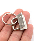 40 Piece All In One Key Fob Hardware Set With 39 One Inch Fob Pieces And 8 Inch Pliers In hand showing silver finish
