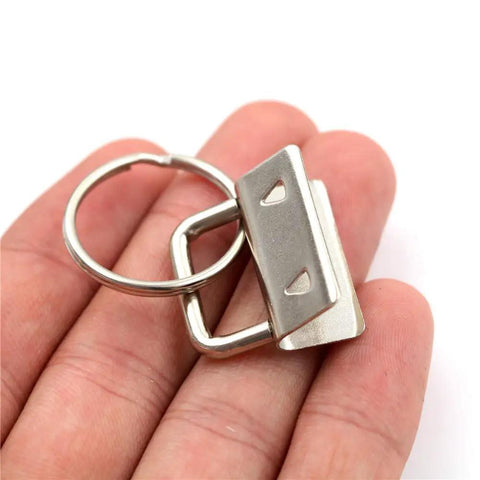 40 Piece All In One Key Fob Hardware Set With 39 One Inch Fob Pieces And 8 Inch Pliers In hand showing silver finish