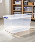 66 Quart Clear Plastic Storage Bin With Secure Blue Latch Lids Stackable Home Organization Tote For Garage Closet And Pantry. Clear, spacious container on a floor.