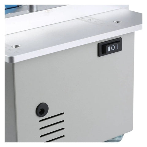 Close-up of Ultra Compact Mini Electric Table Saw With Slick Angle Guide And Quick Lift Blade control switch, indicating power options.