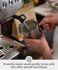 Home Barista Game Changer Smart Bean To Cup Espresso Machine With Intelligent Auto Dosing And Powerful Steam Wand For Dope Microfoam and Smooth Daily Sips In Damson Blue, steaming milk into microfoam.