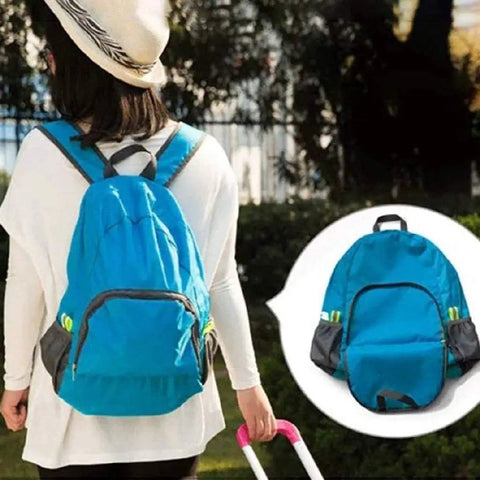 Woman wearing a blue lightweight 20L waterproof hiking backpack with multiple pockets, foldable travel daypack for camping and outdoor adventures