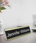 Textured Aluminum Name Plate Holders For Wall And Desk in gold finish, displaying name 'Jennifer Williams' on office desk.