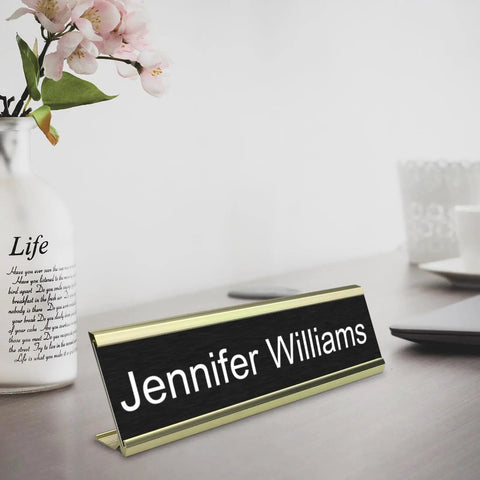 Textured Aluminum Name Plate Holders For Wall And Desk in gold finish, displaying name 'Jennifer Williams' on office desk.