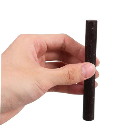 Hand holding one of the 2 Pack Wood Filler Sticks for Furniture Repair Scratch Remover Pens Quick Fix Paint Markers