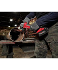 Top Shelf Brushless M18 Compatible Angle Grinder Kit Ships Loaded In Rugged Contractor Bag Featuring Smart Charge Sync And Beast Mode Torque For Serious Crews Jobsite in action cutting metal pipe with sparks flying.