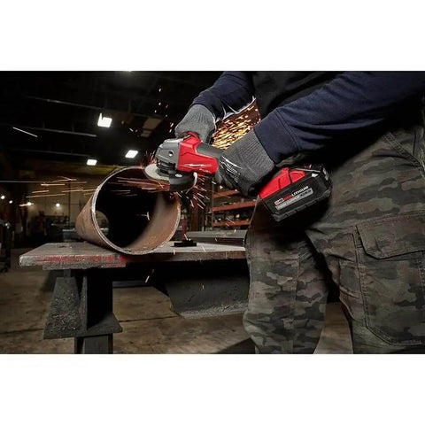 Top Shelf Brushless M18 Compatible Angle Grinder Kit Ships Loaded In Rugged Contractor Bag Featuring Smart Charge Sync And Beast Mode Torque For Serious Crews Jobsite in action cutting metal pipe with sparks flying.