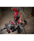 Person using Beast Mode 18 Volt Fuel Lithium Ion Brushless Cordless 10 Inch Dual Bevel Sliding Compound Miter Saw Kit With Free 9Ah Battery for cuts.
