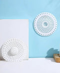 Universal Five Inch Silicone Shower Drain Hair Catcher on a blue background, showcasing flexible design for effective clog prevention.