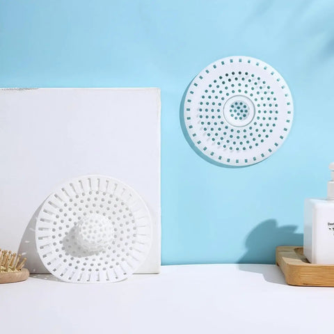 Universal Five Inch Silicone Shower Drain Hair Catcher on a blue background, showcasing flexible design for effective clog prevention.