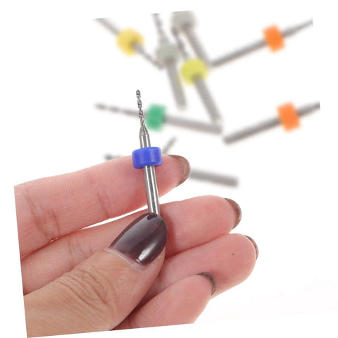 Hand holding blue-capped bit from 30 Piece Micro Drill Bit Set For PCB And Jewelry Pro Grade Precision Hand Drill Engraving Kit Tungsten Steel Bits Tiny Diameter Bits For Circuit Boards Stone Settings And Fine Crafting Projects.