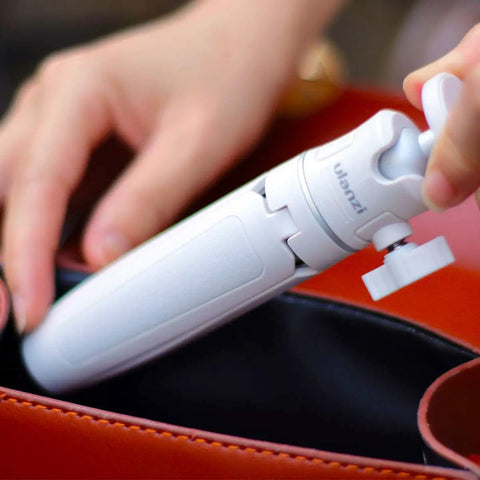 MT-08 White Mini Tripod for Camera with 1 Quarter Inch Mount being placed in a bag