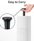 Hand holding sleek Free Standing Toilet Paper Holder with Reserve Function, stainless steel, matte black design.